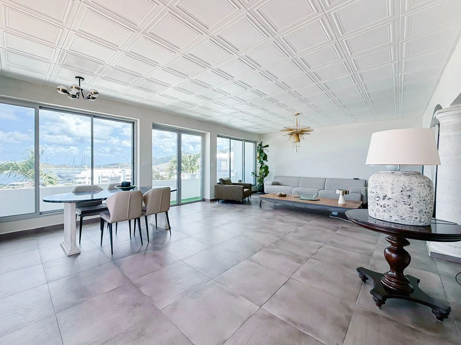 Main living and dining area with sliding glass doors opening to the bay view
