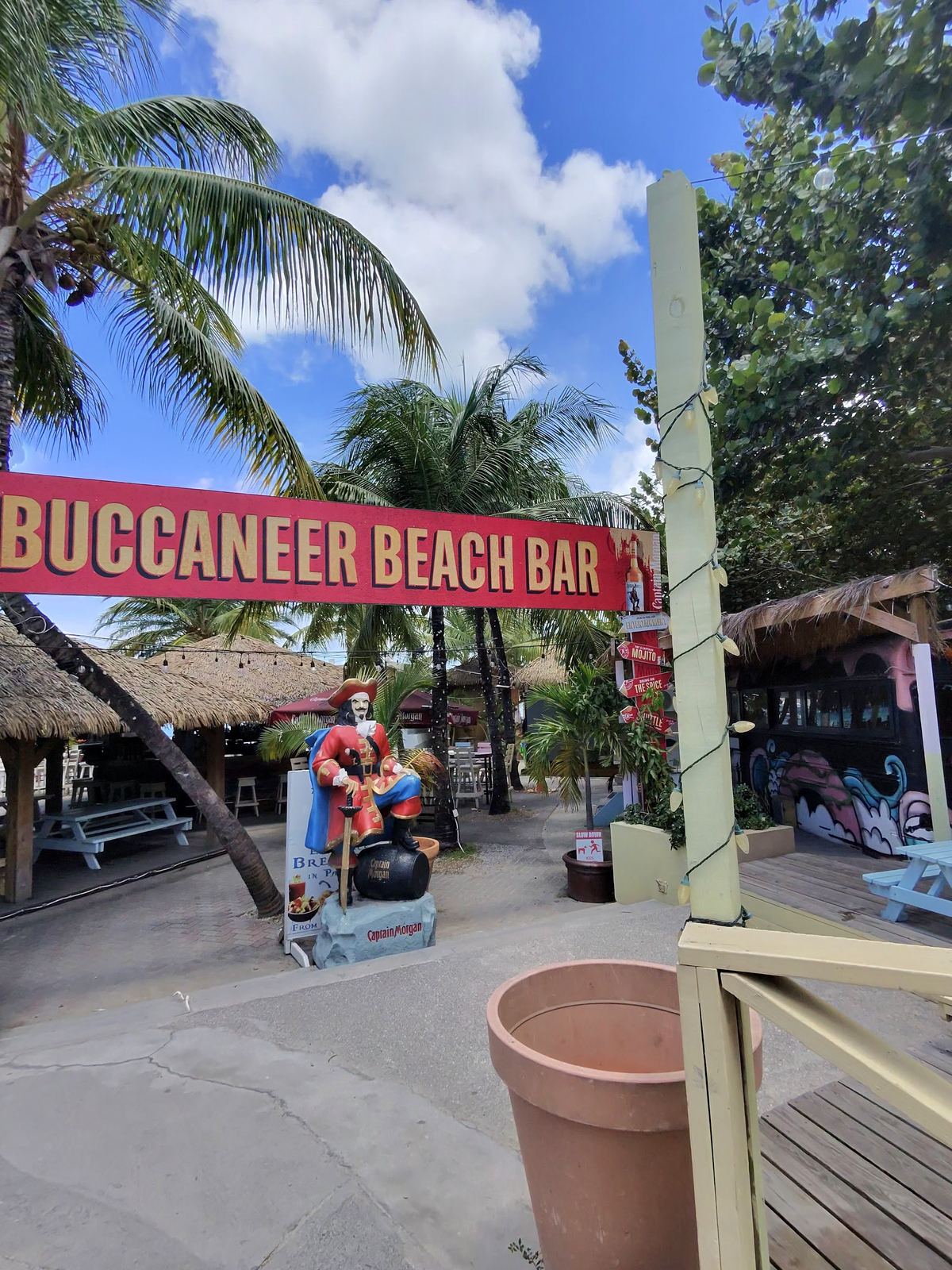 Buccaneer Beach Bar entrance with Captain Morgan statue under palm trees